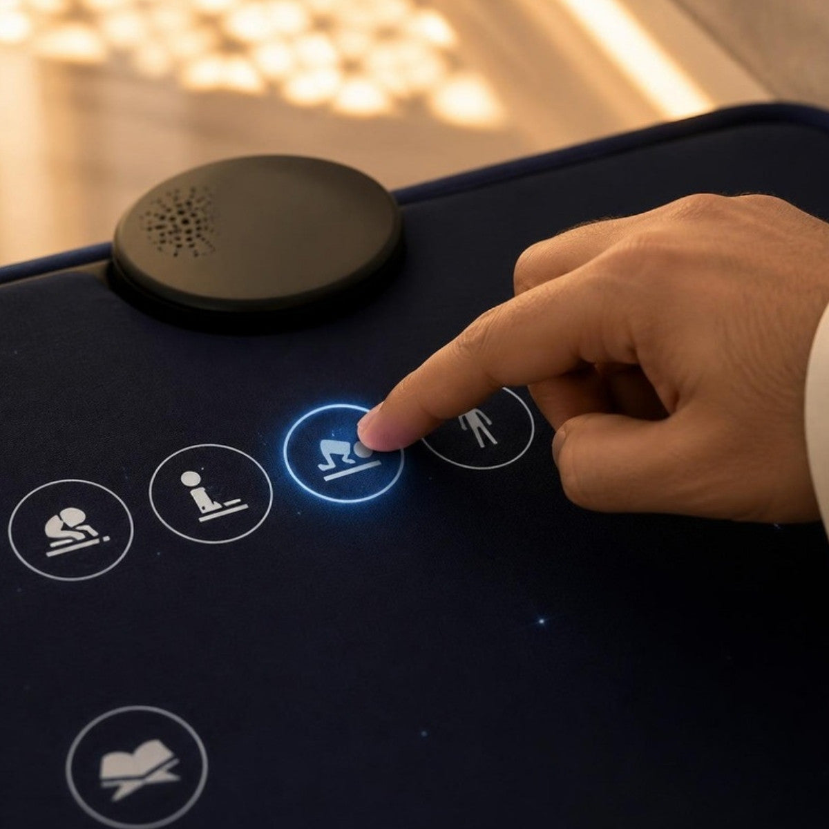 A hand pressing a glowing touch key on the smart prayer mat